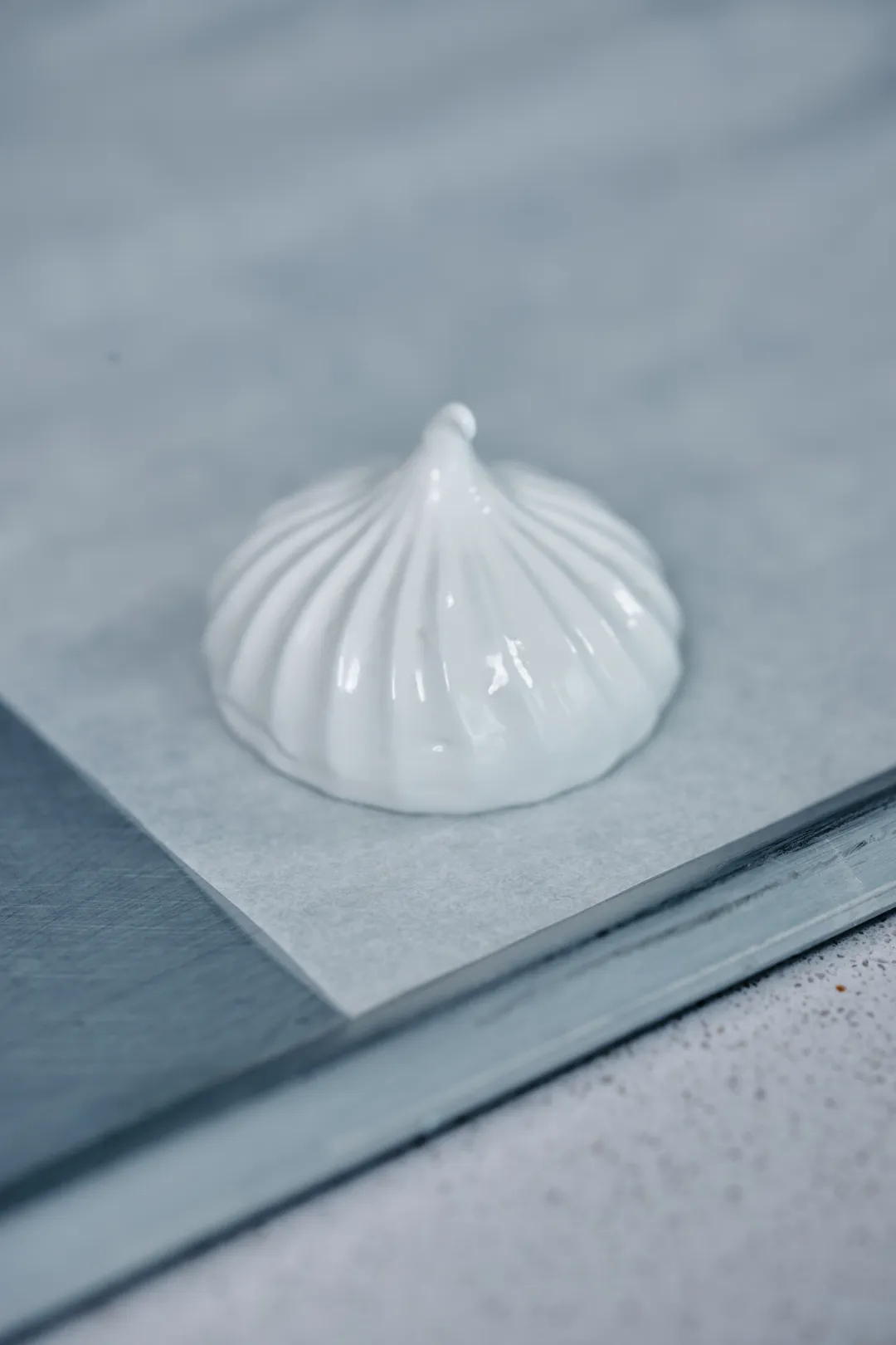 White meringue on parchment-lined baking sheet.